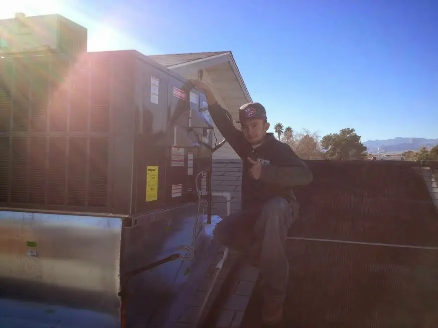 HVAC technician performing HVAC Inspection on a rooftop unit in Casa Grande